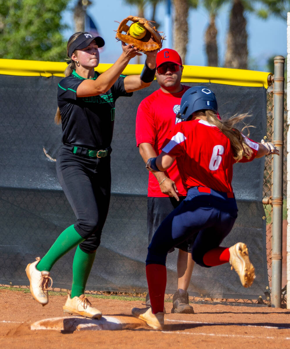 Palo Verde infielder Taylor Johns (11) makes a grab ahead of Coronado runner Sophie Bendlin (6) ...