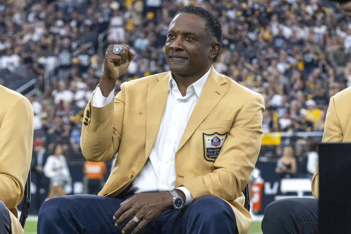 Raiders Hall of Famer Tim Brown pumps his fist on the field as he is introduced during ring cer ...