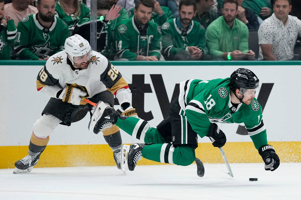 Dallas Stars center Sam Steel (18) is tripped by Vegas Golden Knights' William Carrier (28) in ...