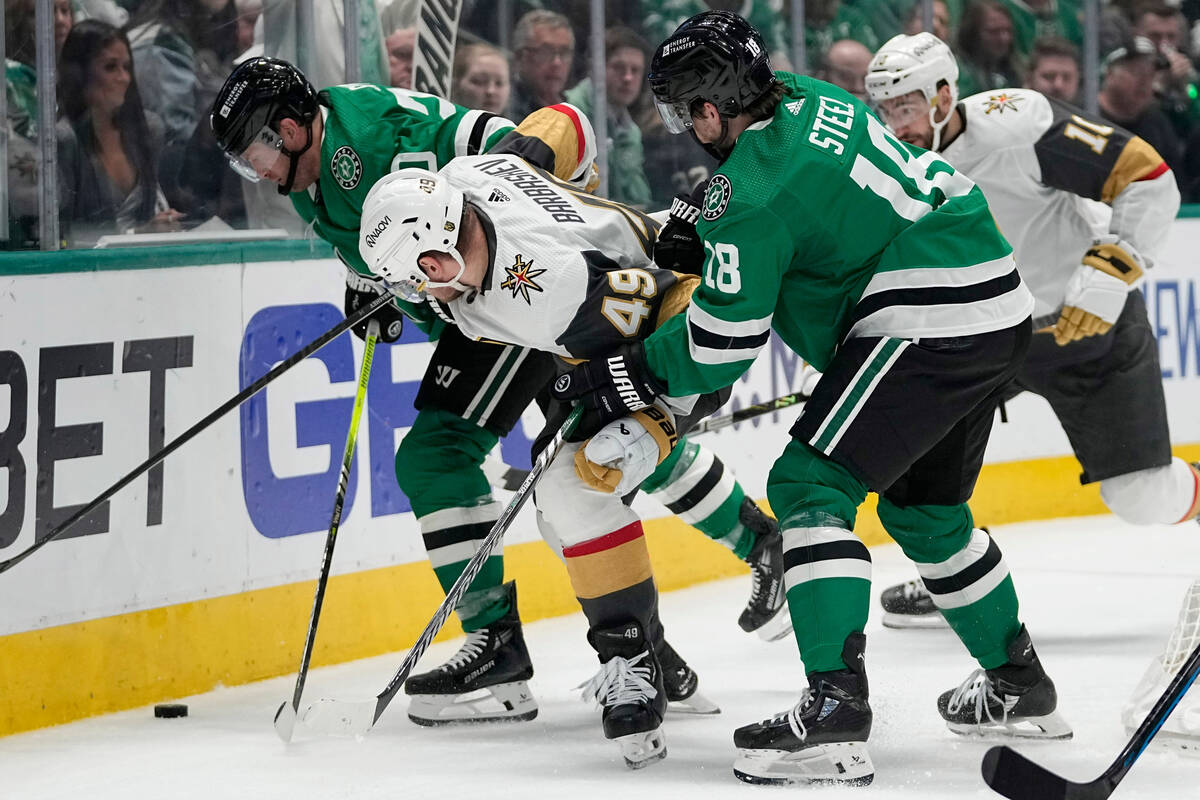 Dallas Stars' Ryan Suter, left, and Sam Steel (18) work to take control of the puck against Veg ...
