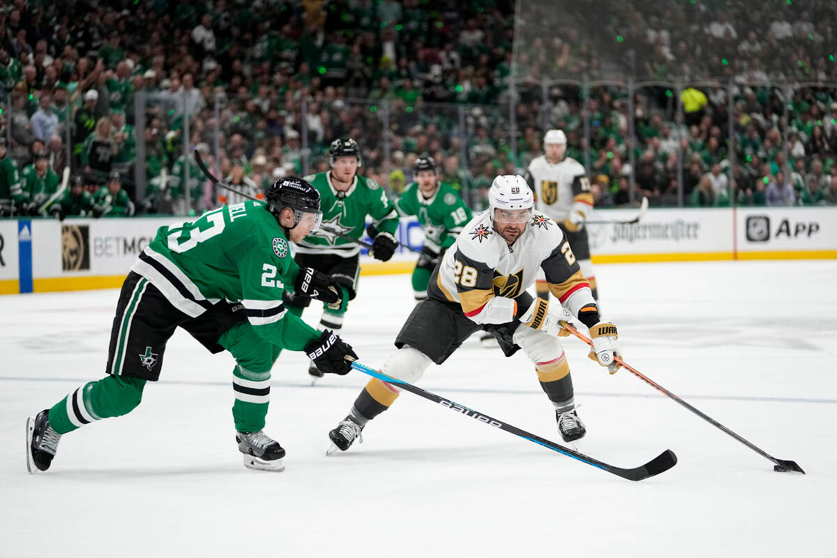 Dallas Stars' Esa Lindell (23) defends as Vegas Golden Knights' William Carrier (28) looks to m ...