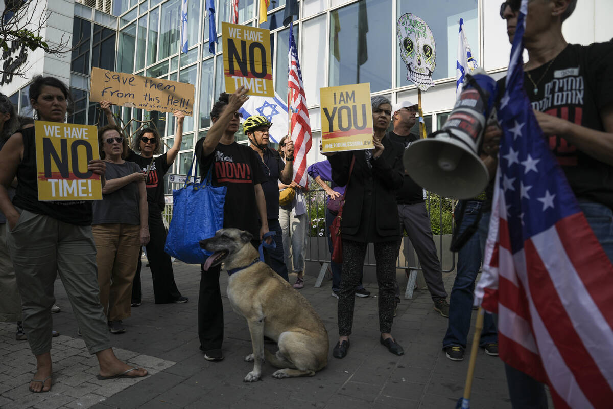 Families and supporters of Israeli hostages held by Hamas in Gaza hold banners and flags during ...