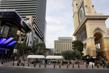 Pedestrians walk past a sliver of land between the Bellagio and The Cosmopolitan is shown on th ...