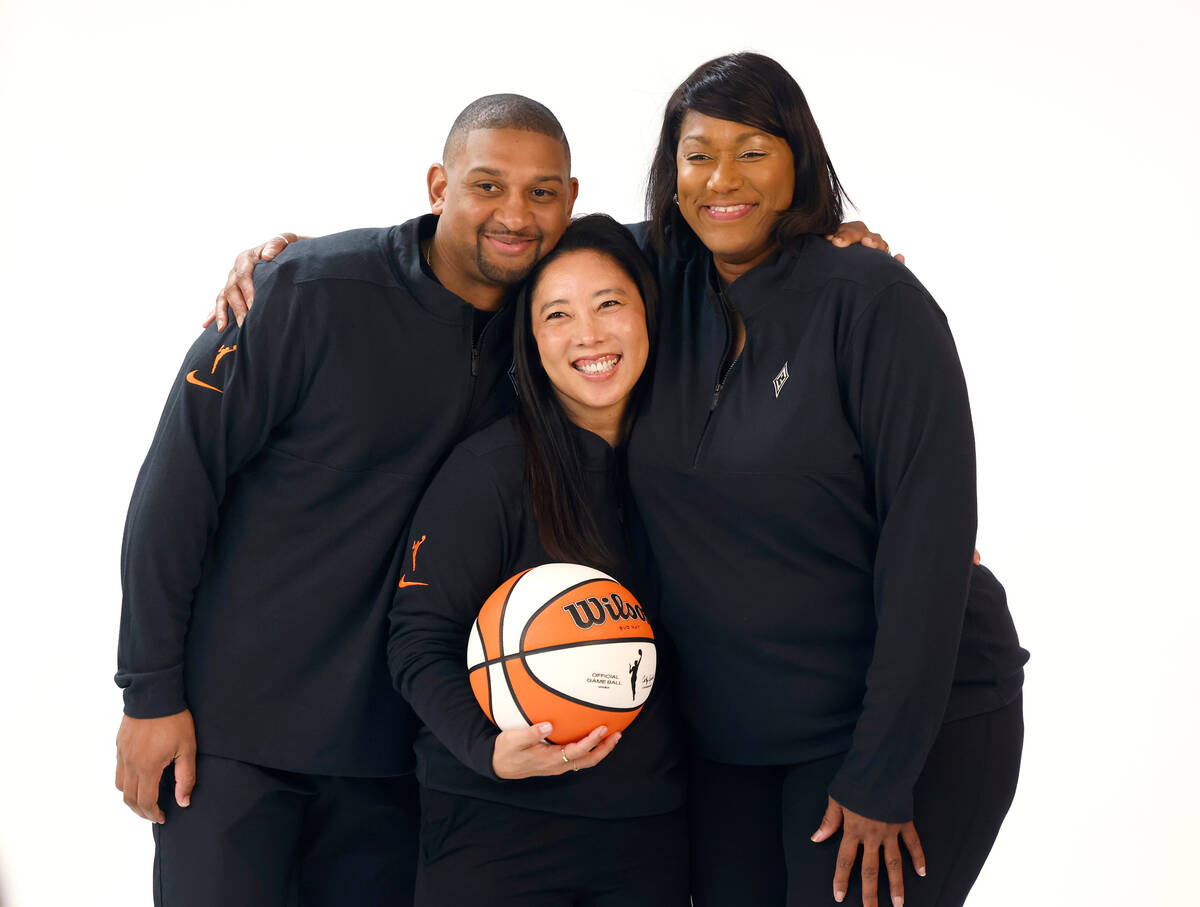 Las Vegas Aces first assistant coach Natalie Nakase center, poses for a photo with assistant co ...