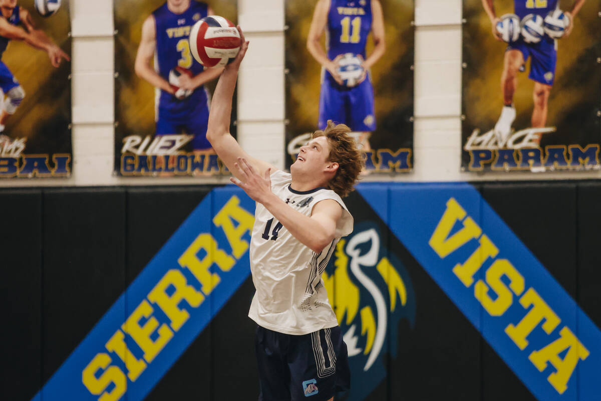 Centennial opposite hitter Andrew Gardner (14) serves the ball during a boys volleyball game be ...