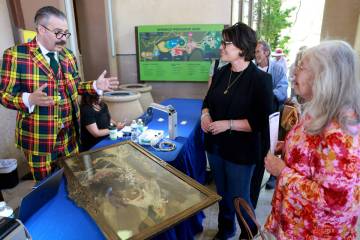 Stephanie and her mother Karin of Las Vegas talk to prints and posters expert Nicholas Lowry du ...