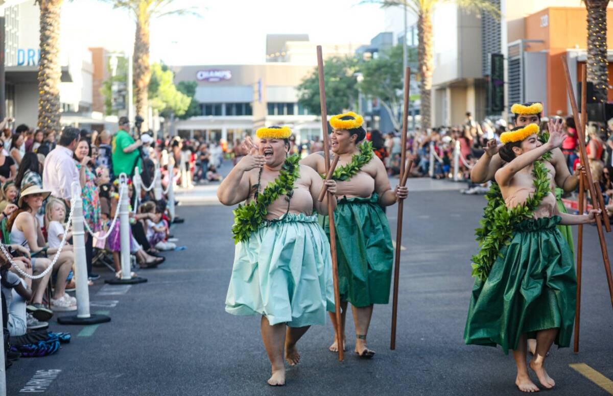 Members of the Nani Ola Hawaiian Dance Company greet guests during the Lei Day Parade, a celebr ...