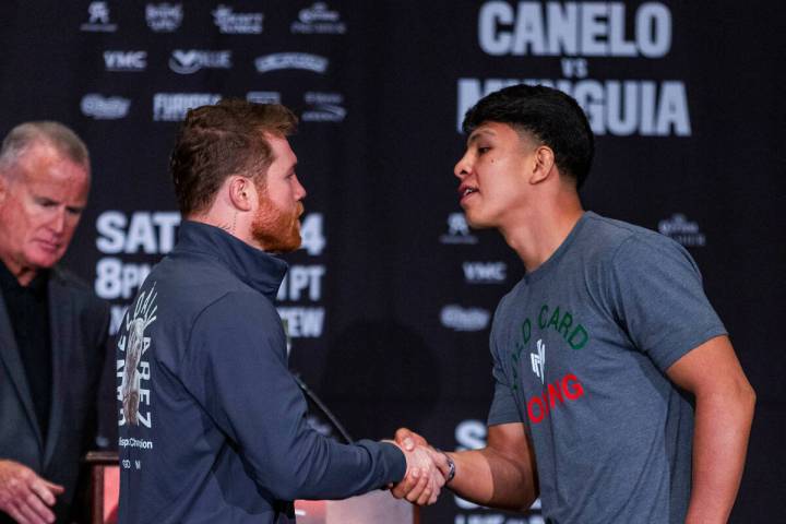 Boxer Canelo Alvarez shakes hands with opponent Jaime Munguia during the final press conference ...