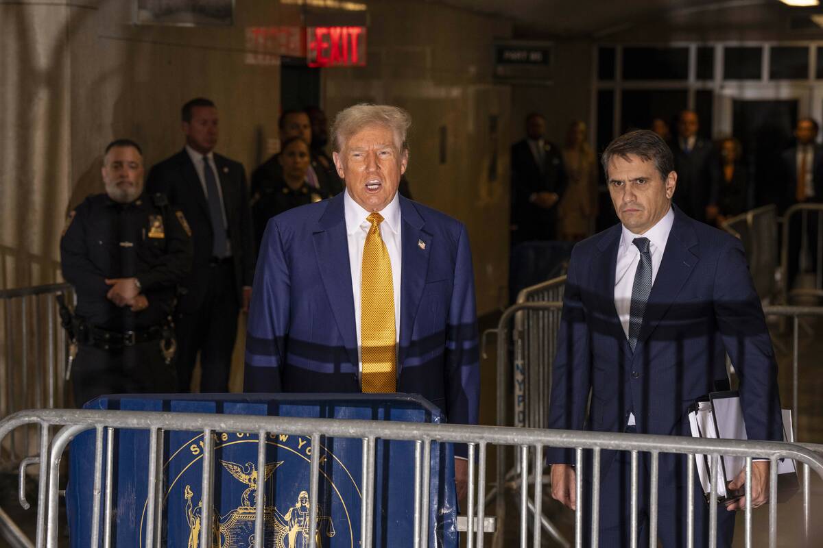 Former President Donald Trump talks to the media outside Manhattan Criminal Court, Thursday, Ma ...