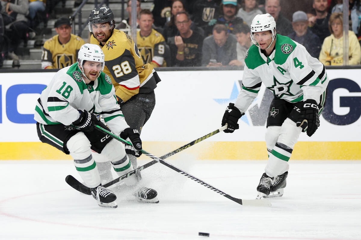 Golden Knights left wing William Carrier (28) watches his pass while Stars center Sam Steel (18 ...