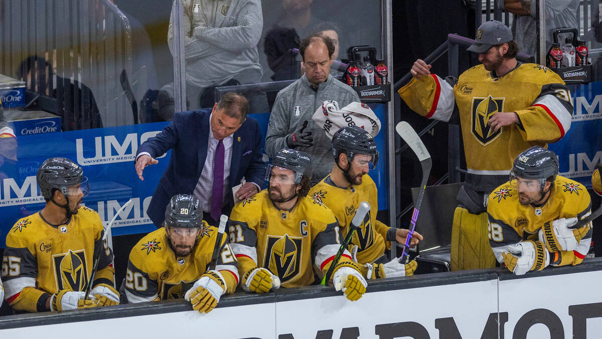 Golden Knights head coach Bruce Cassidy talks with right wing Mark Stone (61) and teammates on ...