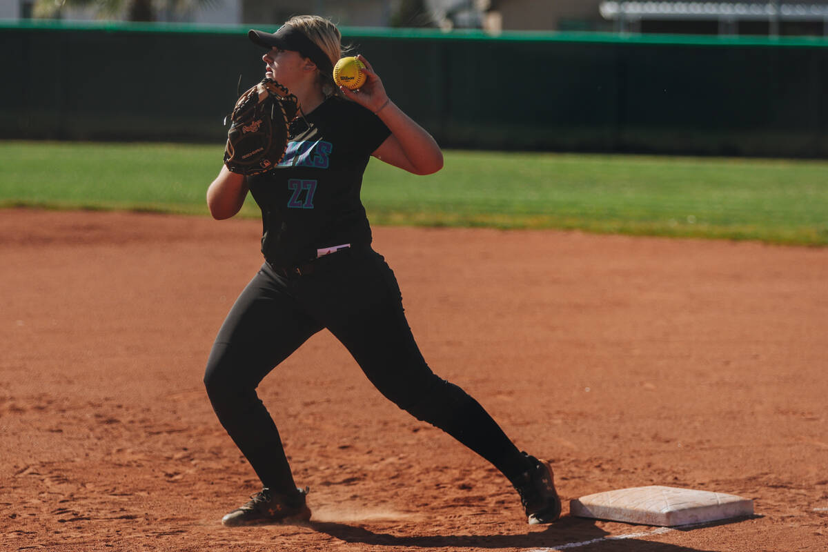 A Silverado player throws the ball from first base during a softball game between Silverado and ...