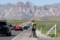 A cyclist stops on State Route 159 in Red Rock Canyon National Conservation Area outside of Las ...