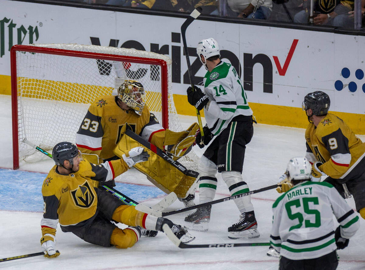 Golden Knights goaltender Adin Hill (33) snags a puck in front of Dallas Stars left wing Jamie ...