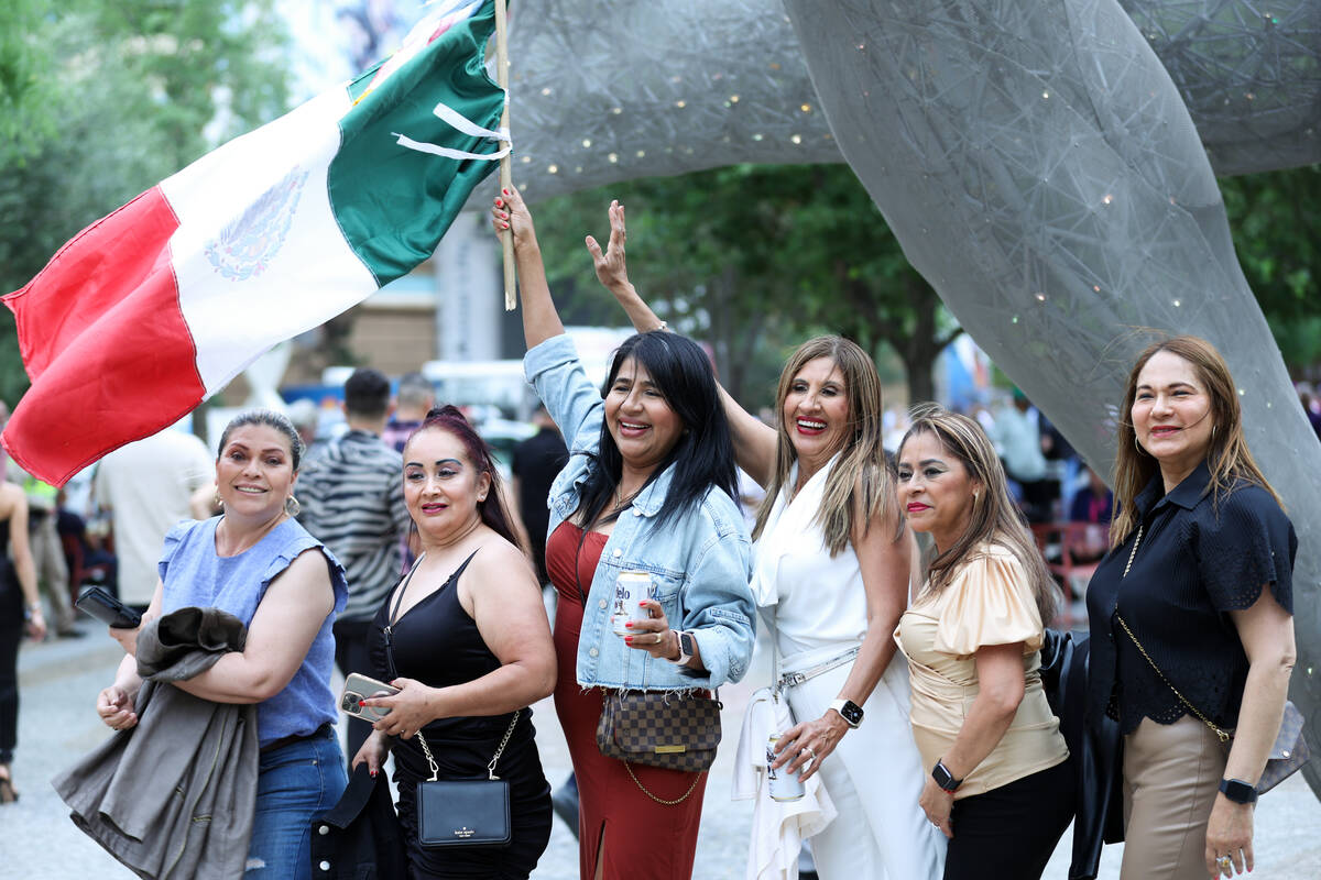 Fans pose for photos with the Mexican flag before a boxing event at T-Mobile Arena on Saturday, ...