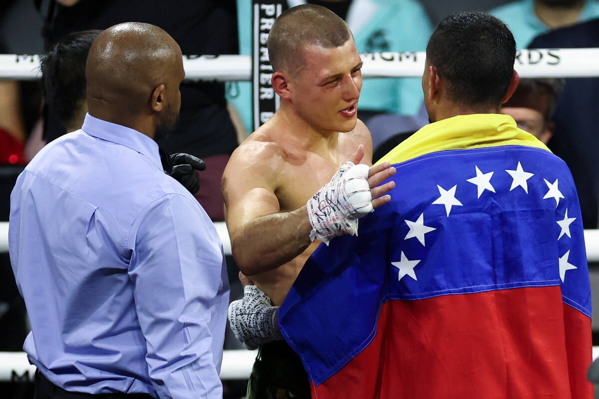 Eimantas Stanionis consoles Gabriel Maestre after winning their WBA world welterweight champion ...