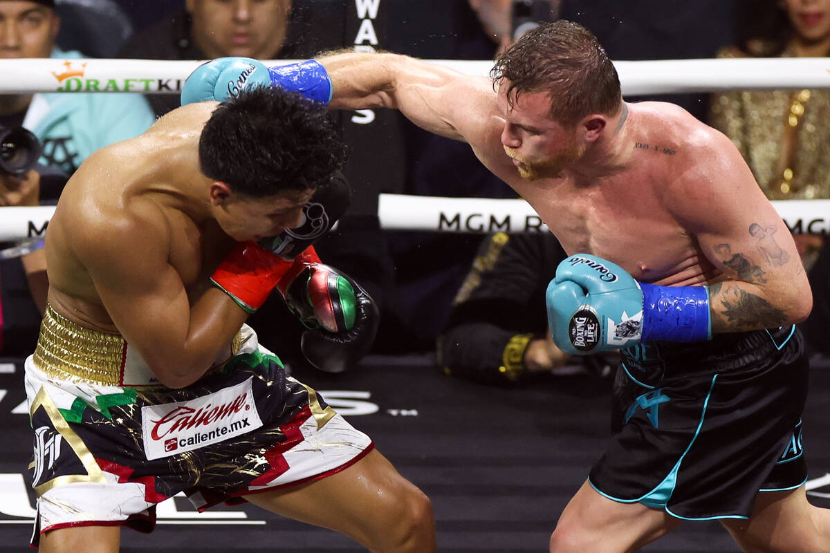Canelo Álvarez hits Jaime Munguía during an undisputed world super middleweight champ ...