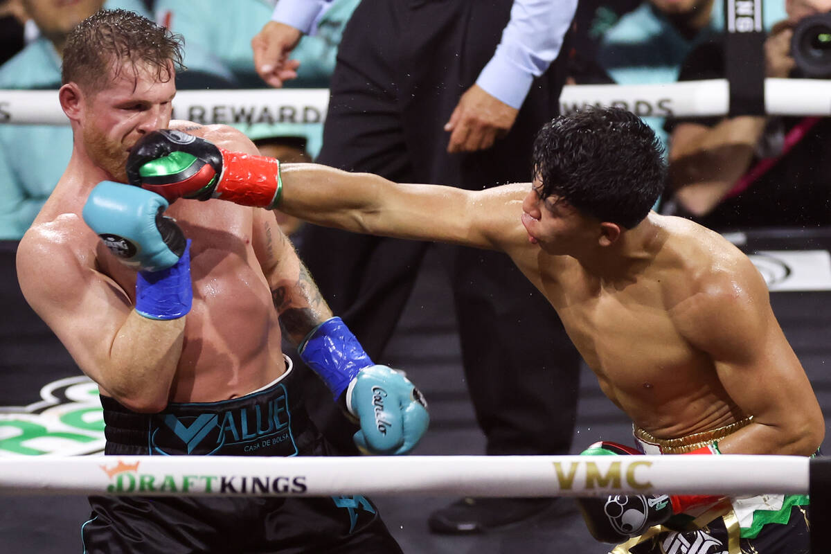 Jaime Munguía gets a right on Canelo Álvarez during an undisputed world super middlew ...