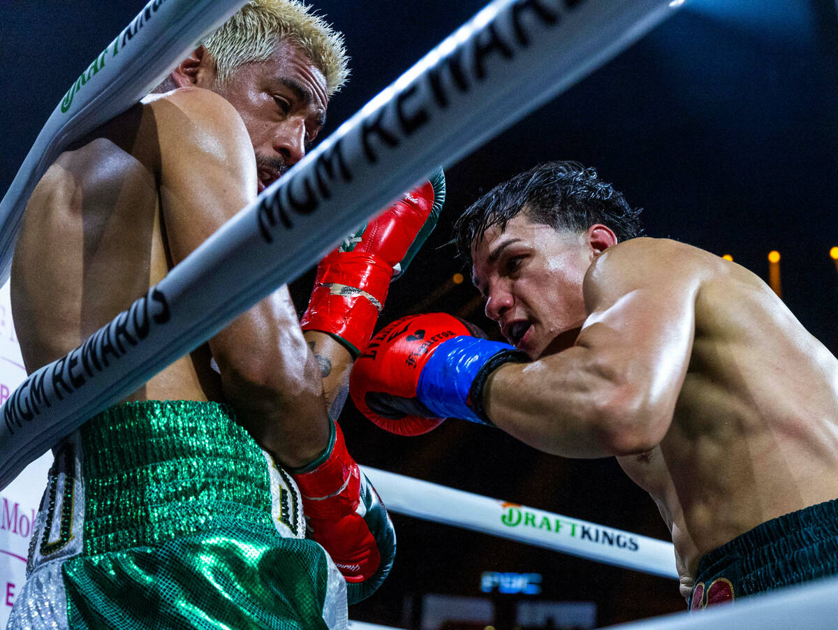 Featherweight Jessie Magdaleno is driven into the ropes by Brandon Figueroa during the fourth r ...