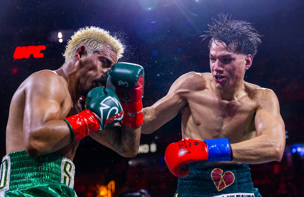 Featherweight Jessie Magdaleno is punched in the chin by Brandon Figueroa during the eighth rou ...