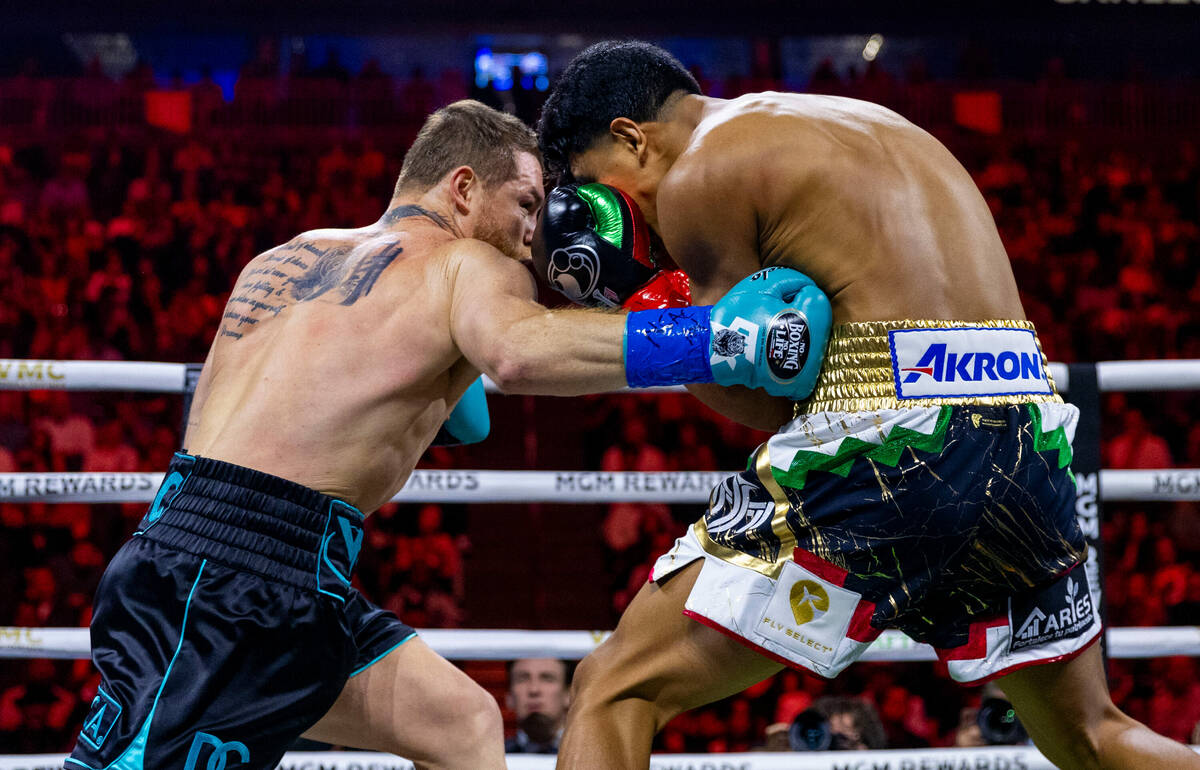 Canelo Alvarez drives a punch into the side of Jaime Munguia during the first round of their PP ...