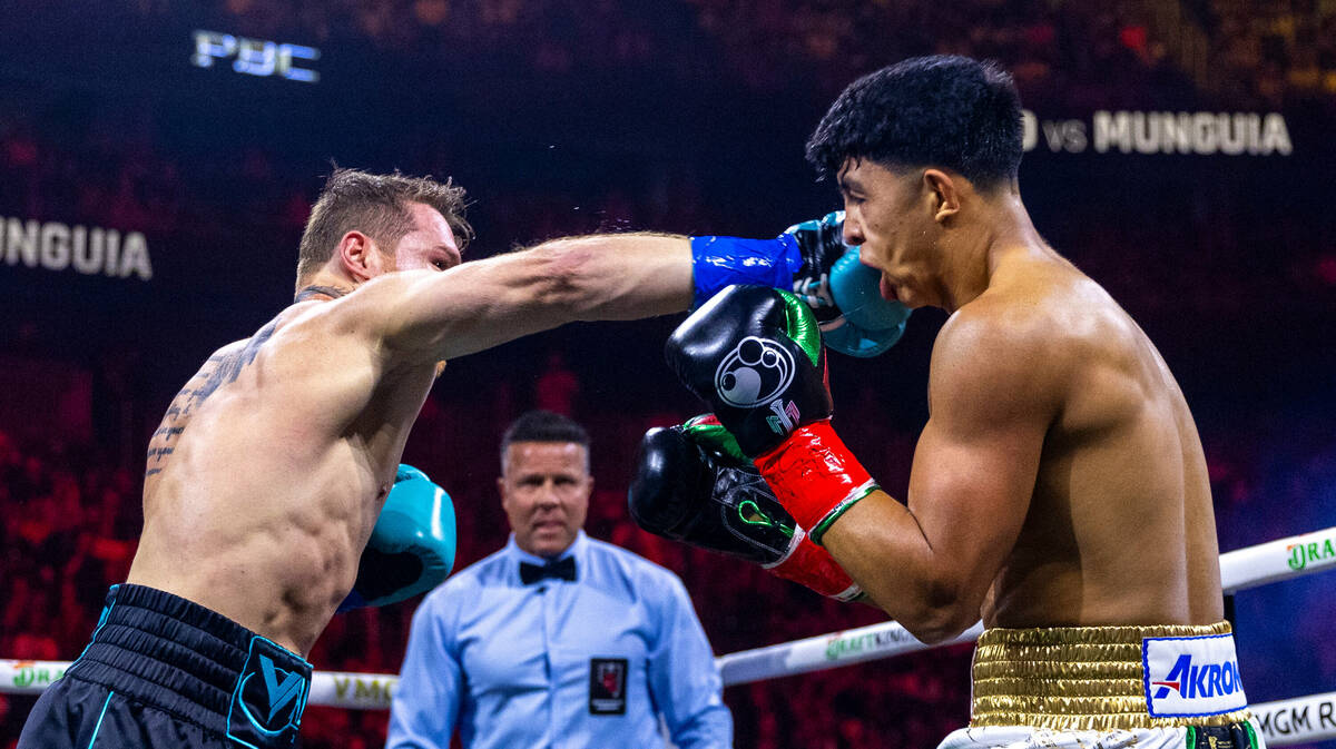 Canelo Alvarez connects with a punch to the chin of Jaime Munguia during the first round of the ...