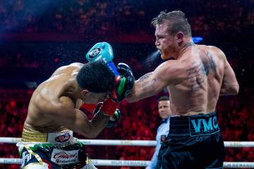 Jaime Munguia takes a shot to the head from Canelo Alvarez during the ninth round of their PPV ...