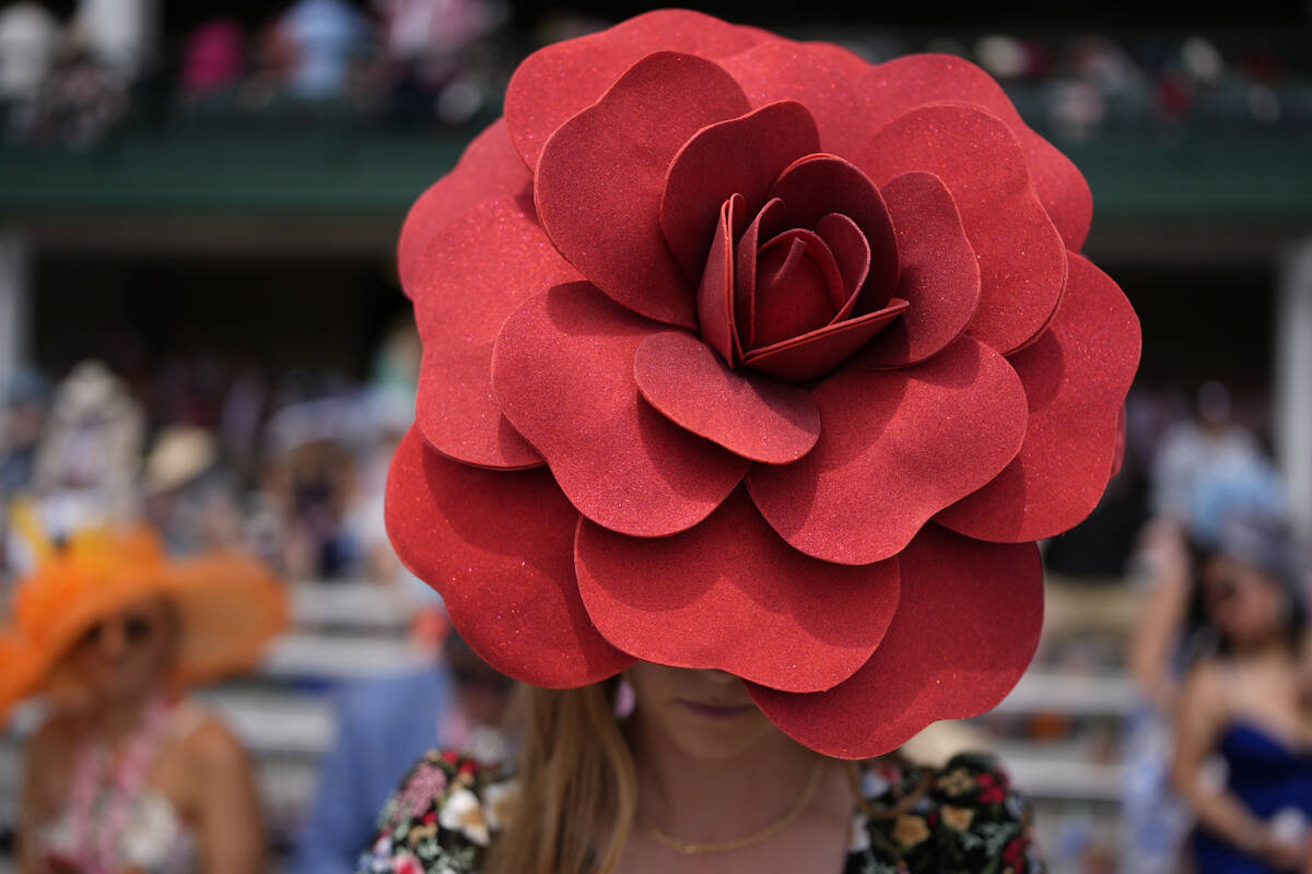 A race fan walks though the stands at Churchill Downs before the 150th running of the Kentucky ...