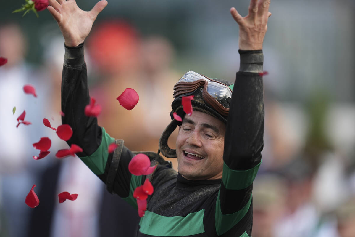 Brian Hernandez Jr. celebrates in the winner's circle after riding Mystik Dan to win the 150th ...