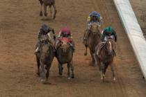 Brian Hernandez Jr. rides Mystik Dan, right, across the finish line to win the 150th running of ...