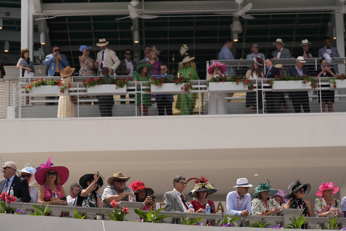 Race fans watch the paddock at Churchill Downs before the 150th running of the Kentucky Derby h ...