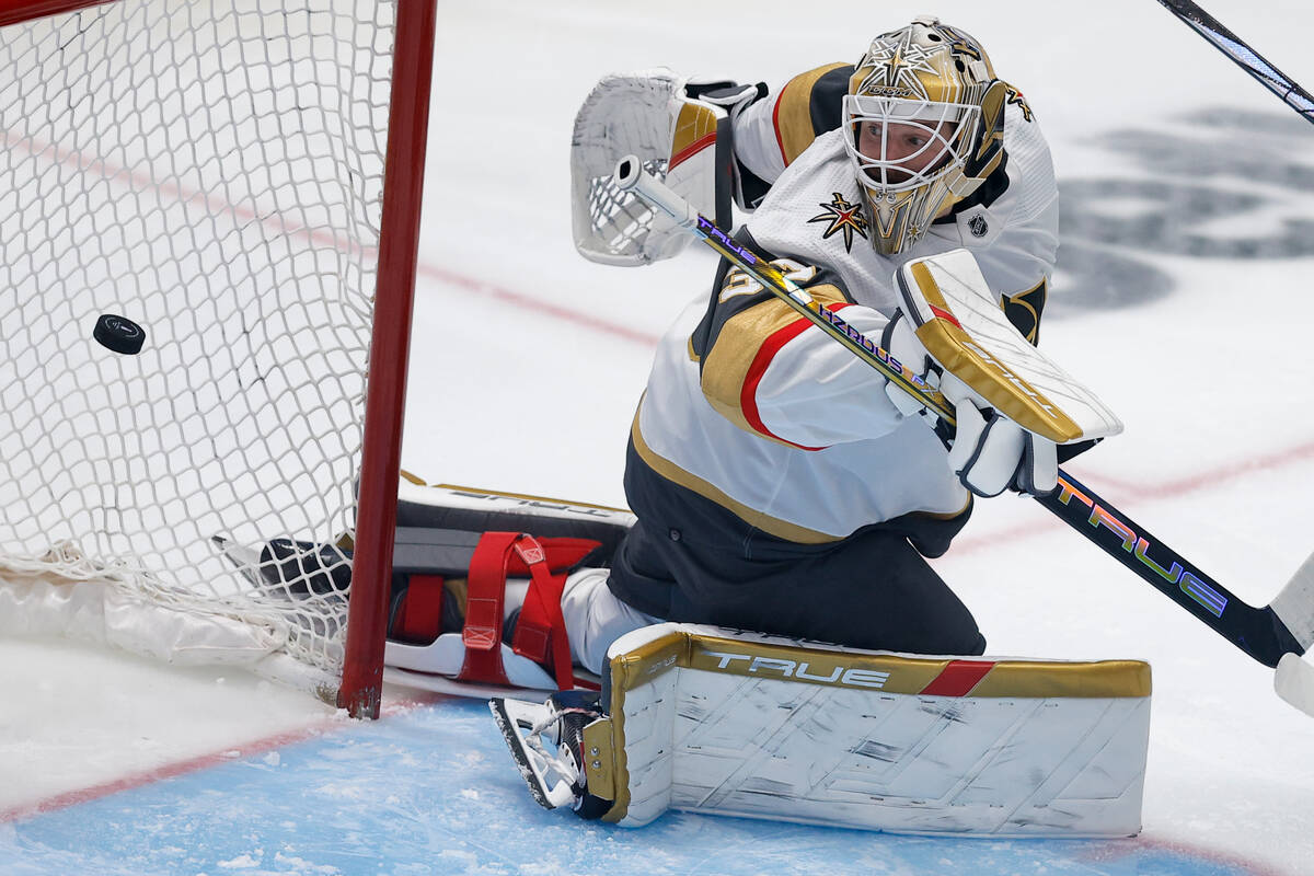 Vegas Golden Knights goaltender Adin Hill eyes the puck on a scoring shot by Dallas Stars cente ...