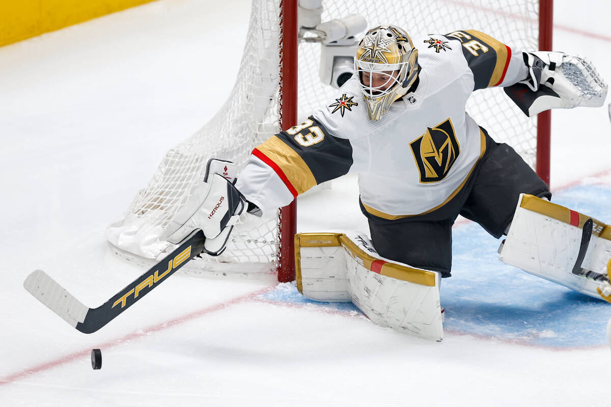 Vegas Golden Knights goaltender Adin Hill deflects a shot during the first period in Game 7 of ...