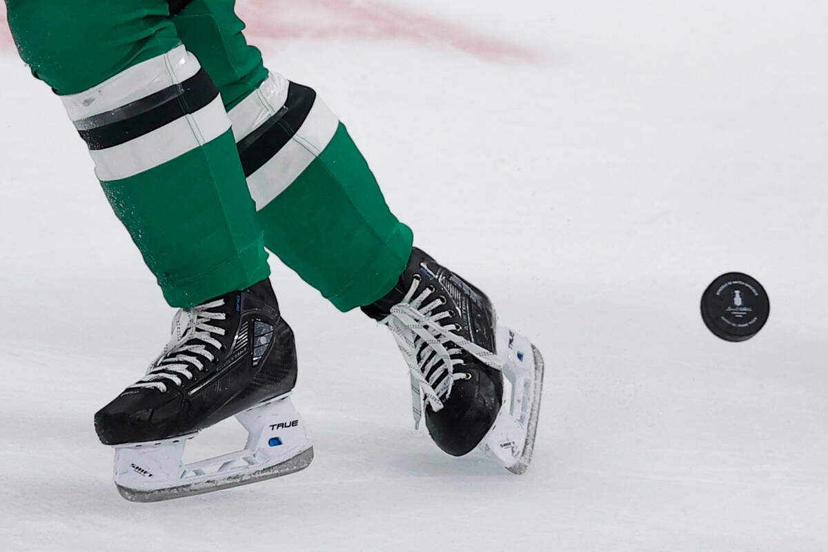 The Stanley Cup Playoffs logo is seen as Dallas Stars center Logan Stankoven (11) skates near i ...