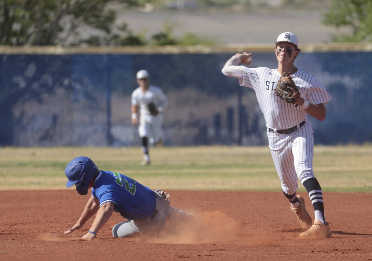 Shadow Ridge's Brock Morrow, right, throws to first base after tagging out Green Valley's Brand ...