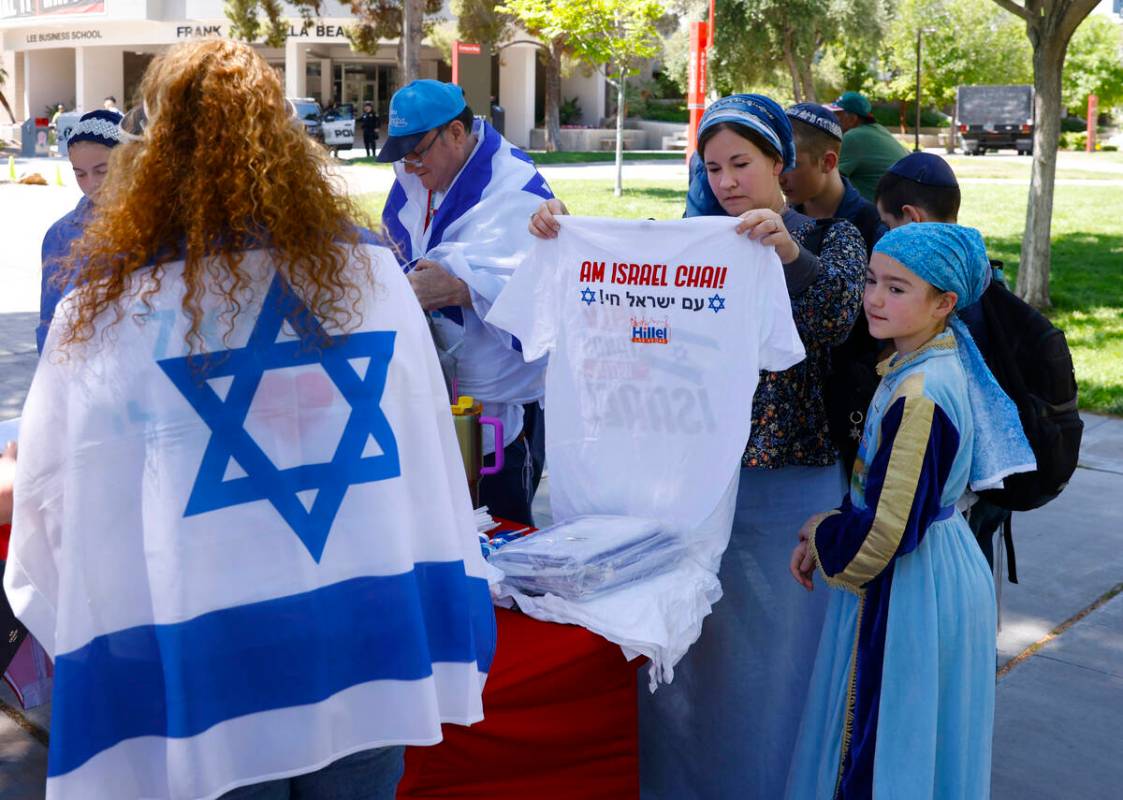 Lydia Netan, second right, checks out "We Stand With Israel" t-shirt as her daughter ...