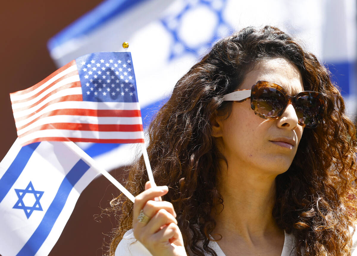 Anat Meged-Nisgoda holds American and Israeli flags as she attends Stand Against Hate Rally, su ...