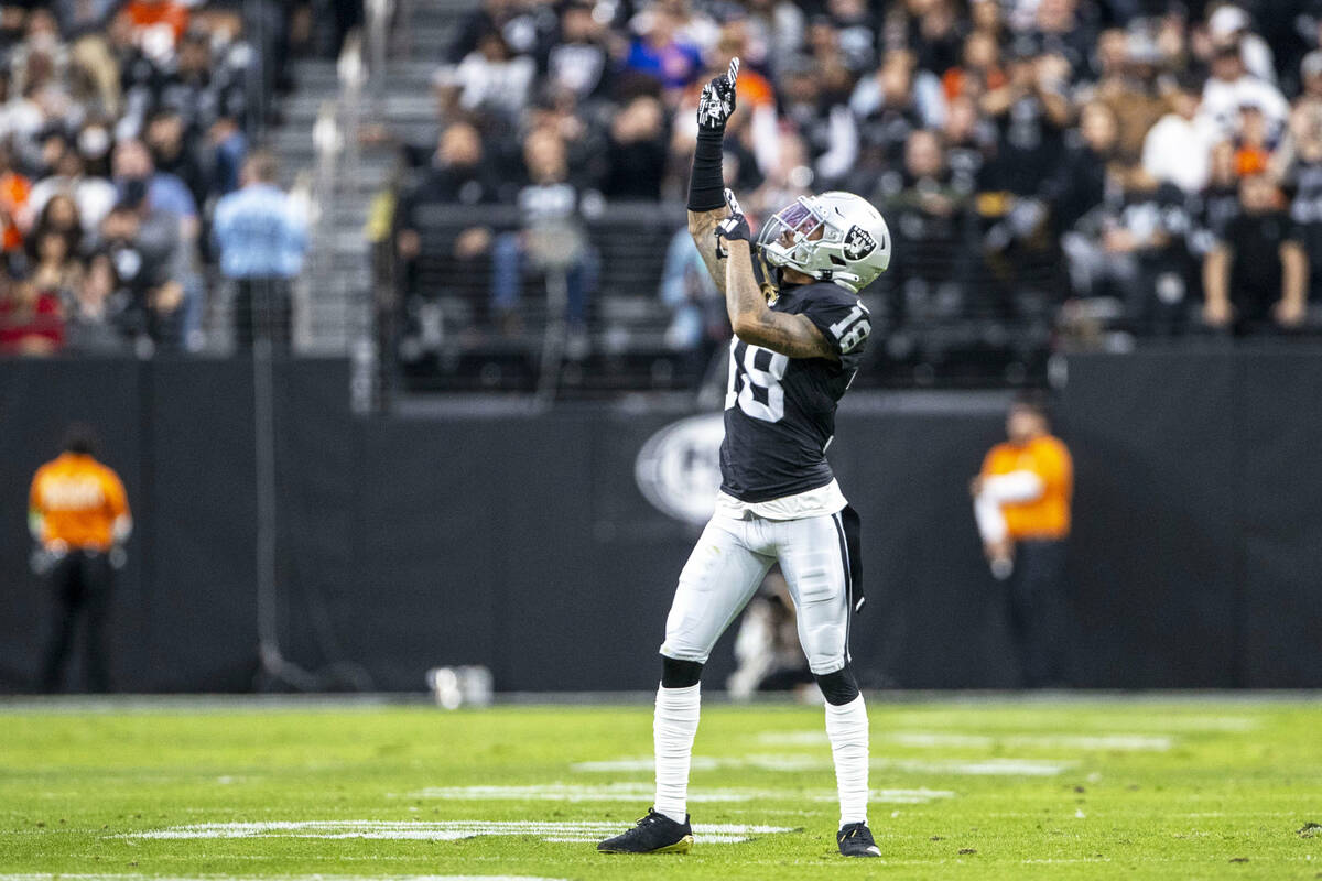 Raiders cornerback Jack Jones (18) reacts after a flag thrown on the field was a penalty agains ...