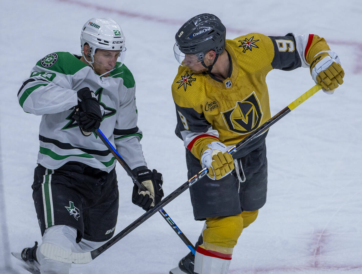 Golden Knights center Jack Eichel (9) and Dallas Stars defenseman Esa Lindell (23) fight for po ...