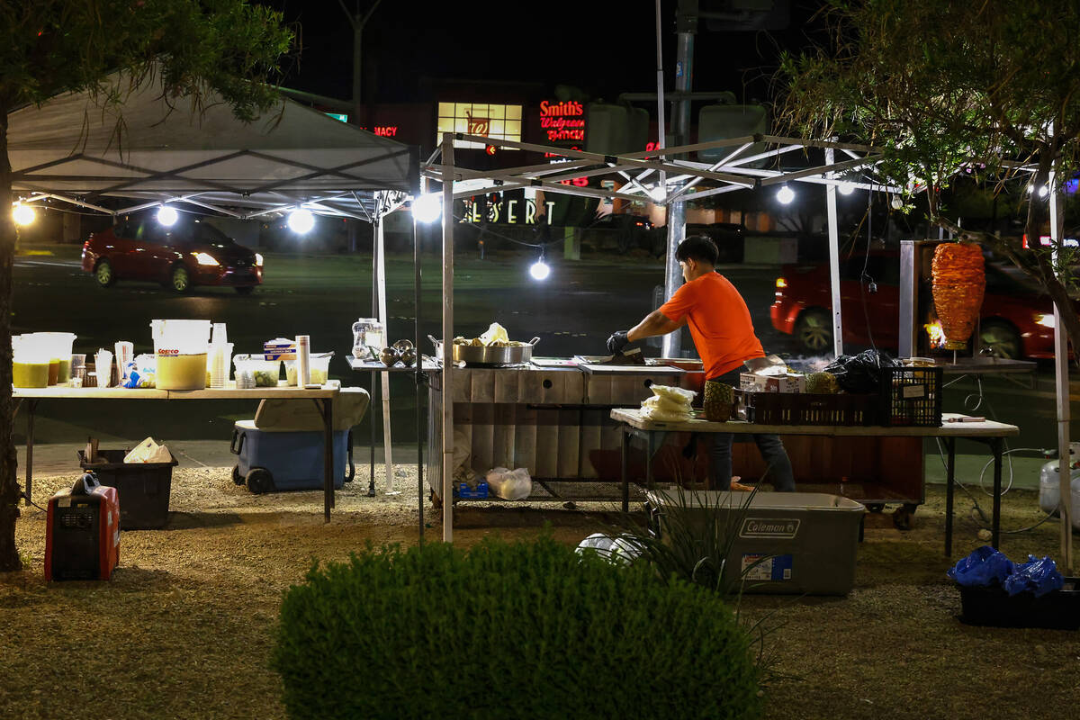 Jaime Melendez works at his taco stand at the corner of Durango Drive and Warm Springs Road, on ...