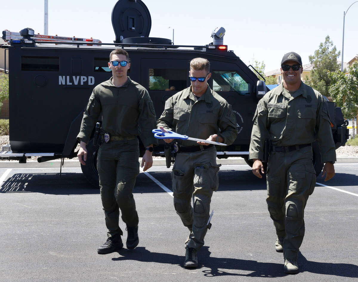 Joshua Kleintholz, center, a member of the North Las Vegas Police Department SWAT team, deliver ...