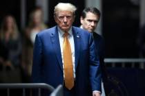 Former President Donald Trump, followed by his attorney Todd Blanche, walks to speak to reporte ...