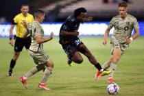 Las Vegas Lights FC midfielder J.C. Ngando (26) works the ball away from Los Angeles FC defende ...