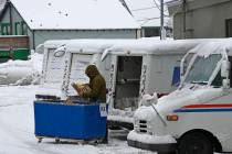 A mail carrier loads a mail truck with mail, March 1, 2024, in Lake Tahoe. (AP Photo/Andy Barro ...