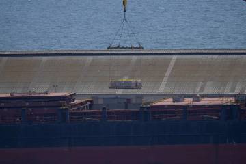 A crane loads food aid for Gaza onto the container ship Sagamore docked at Larnaca port, Cyprus ...
