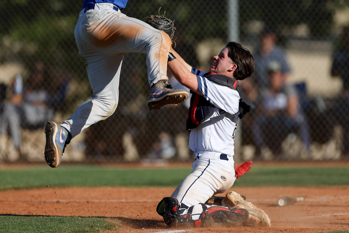 Coronado catcher AJ Stalteri tags out Green Valley's Caden Kirby, obscured at left, as he attem ...