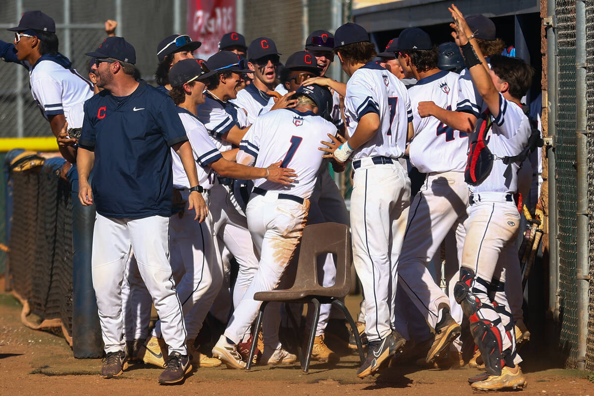 Coronado congratulates pitcher Evan Festa after scoring during a Class 5A high school baseball ...