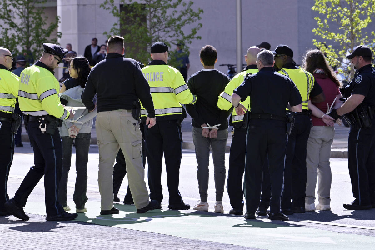 Police detain three a pro-Palestinian demonstrators who attempted to block traffic to the garag ...