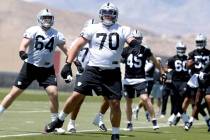 Raiders rookie guard Jackson Powers-Johnson (70) warms up during rookies first day of practice ...