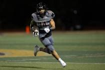 Faith Lutheran running back Cale Breslin (14) runs the ball during the first half of a high sch ...